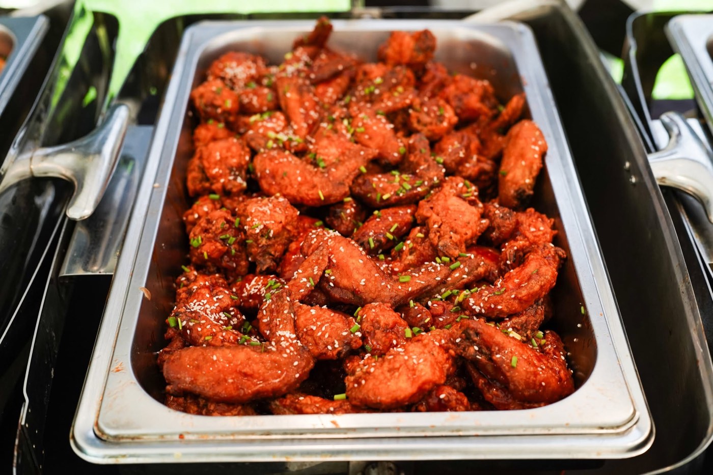 Buffalo wings in a catering chafing tray