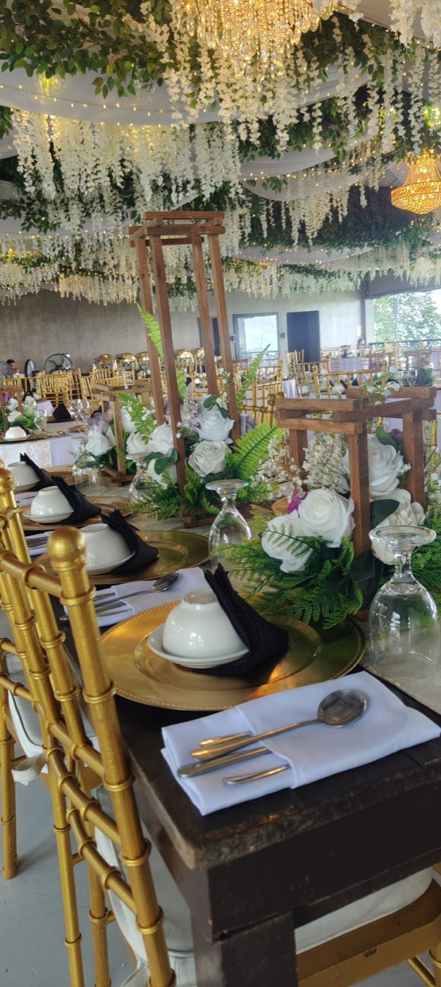 A formal tablescape under a hanging wisteria floral ceiling installation